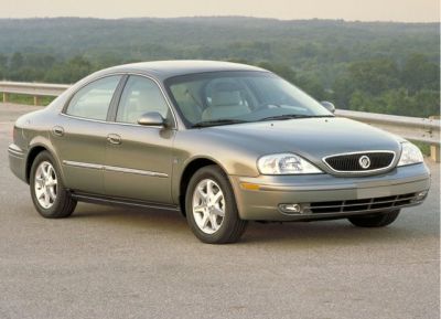 Front side view of a sedan with smooth lines and distinctive grille.