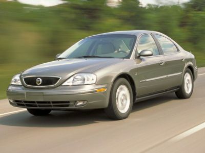 Front grille and headlights of a 2000s sedan on road