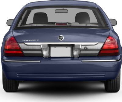 Rear view of sedan with distinct taillights and emblem on trunk