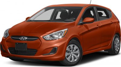 Front side view with headlight and alloy wheels of orange hatchback