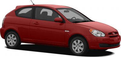 Side profile of red two-door hatchback with alloy wheels.