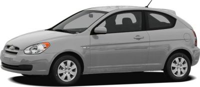 Side profile of a compact hatchback with silver paint and five-spoke wheels.