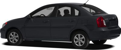 Side profile of a compact 4-door sedan with alloy wheels