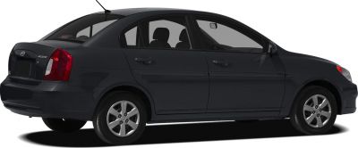 Side and rear view of a compact sedan with four doors and alloy wheels