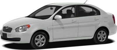 White compact sedan with side profile and alloy wheels