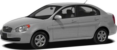 Side profile of a compact four-door sedan with alloy wheels