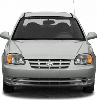 Front view of a car with grille, headlights, and fog lights