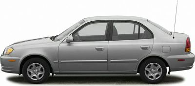 Side profile of a compact four-door sedan with smooth lines and alloy wheels.