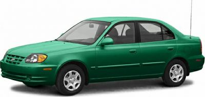 Green four-door sedan front-side view