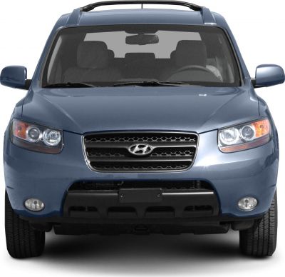 Front view with grille, dual round headlights, and fog lights
