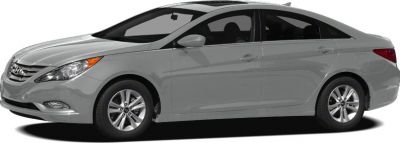 Side profile of a sedan with curved roofline and alloy wheels.