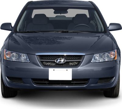 Front view with signature headlights and grille with emblem