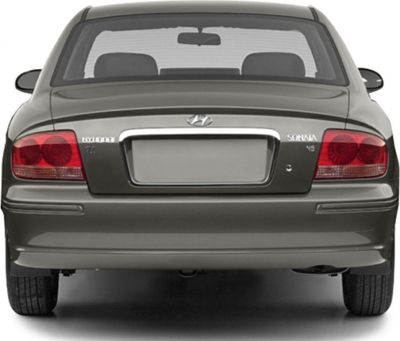 Rear view with taillights, badge, trunk and bumper of a classic sedan