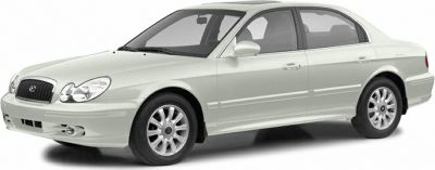 Front-side angle of a white sedan with distinct headlights and alloy wheels