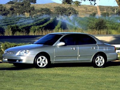 Silver four-door sedan with alloy wheels, side profile view