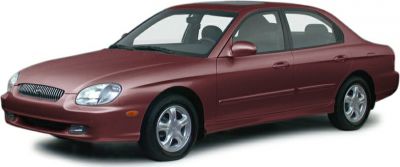 Front and side profile of a red sedan with a smooth aerodynamic design and alloy wheels.