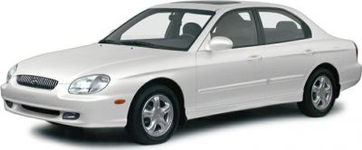 White mid-size sedan with distinctive headlights and alloy wheels