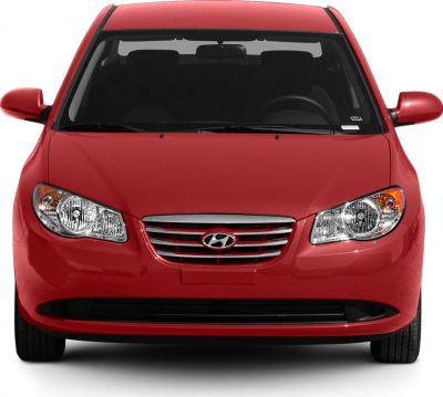 Front view with headlights and grille of a red sedan