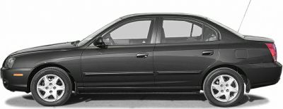 Side profile of a compact four-door sedan with alloy wheels