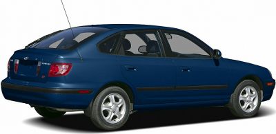 Rear-side view of a compact hatchback with alloy wheels and antenna