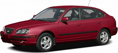 Side profile of a red aerodynamic five-door hatchback with alloy wheels.