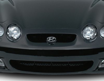 Round headlights and central grille with emblem on front end