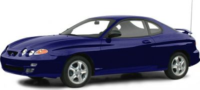 Side view of a classic sports coupe with triple front headlights and rear spoiler