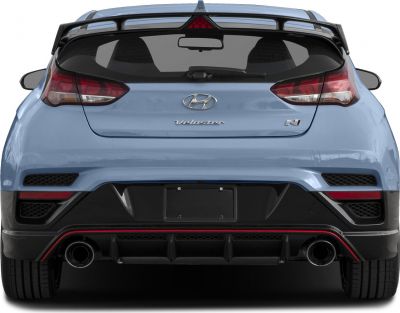 Dual exhaust pipes, rear diffuser, and spoiler on hatchback rear