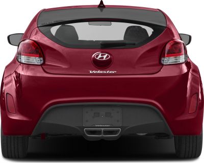 Rear hatchback view with dual exhausts and distinctive tail lights