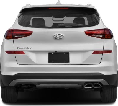 Rear view showing taillights and dual exhaust of a white SUV