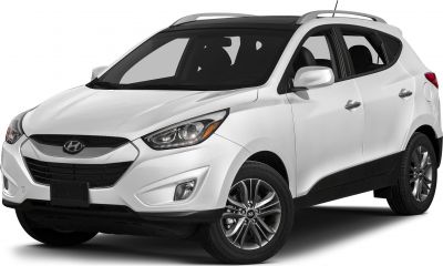 Front side view of white SUV with sleek headlights and alloy wheels