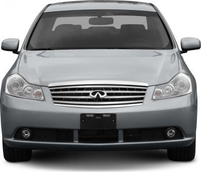Front sedan view with dual round headlights and chrome grille