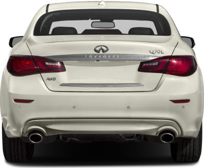 Rear view with AWD badge, taillights, and dual exhausts on white sedan