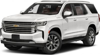 Front side view of white large SUV with prominent grille and alloy wheels
