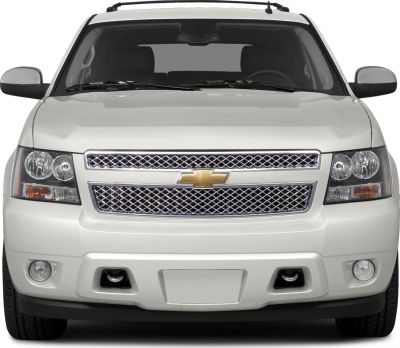 Large SUV front with chrome mesh grille and fog lights