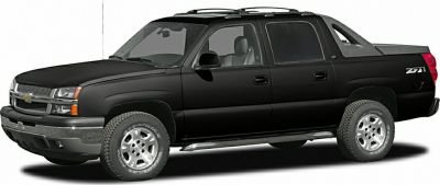 Side view of a black crew cab pickup with alloy wheels and off-road package