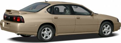 Rear spoiler and alloy wheels on a mid-2000s sedan