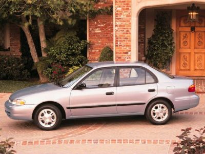 Side profile of a compact sedan parked in a residential driveway.
