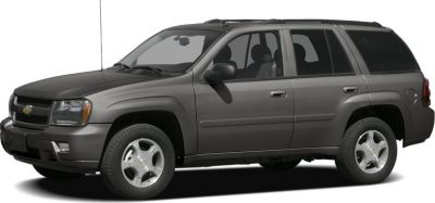 Side profile of a gray mid-size SUV with four doors and roof rack