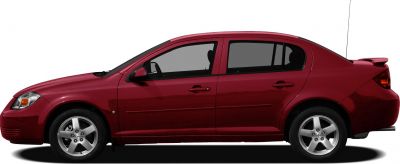 Side view of a red compact sedan with sporty rear spoiler and alloy wheels.
