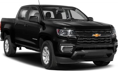 Black mid-size pickup front-side with bold grille and headlights
