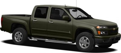 Double cab pickup truck with chrome wheels and side steps.
