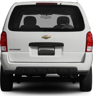 Rear view of a minivan with rear windshield, tail lights, and emblem