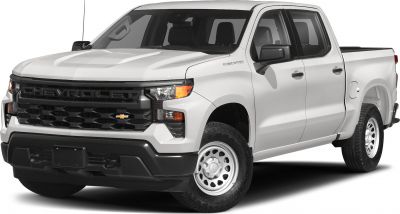 Front grille and headlights of a white crew cab pickup with short box.