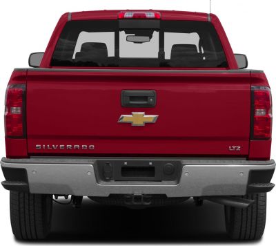 Rear view of a pickup’s tailgate with bumper and cab window