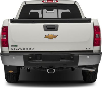 Rear view showing tailgate, bumper, towing hitch, and tinted window
