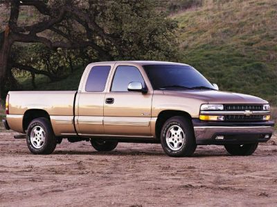 Side view of an extended crew cab pickup truck on rough ground