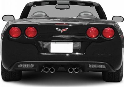 Rear close-up of convertible with round taillights and quad exhaust pipes.