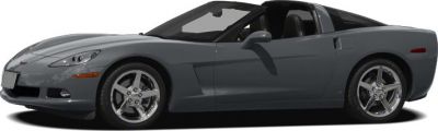 Side profile of a gray sports coupe with alloy wheels.