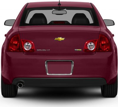 Rear view with distinctive taillights, badges, exhaust pipe, and rear window